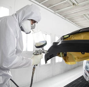 Collision Center Technician Painting a Vehicle | Wyatt Johnson Toyota in Clarksville TN