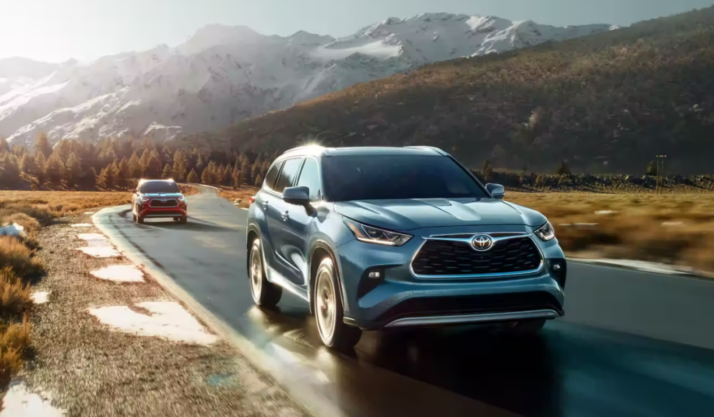 Two new 2023 Toyota Highlanders embark on a road trip through the mountains.