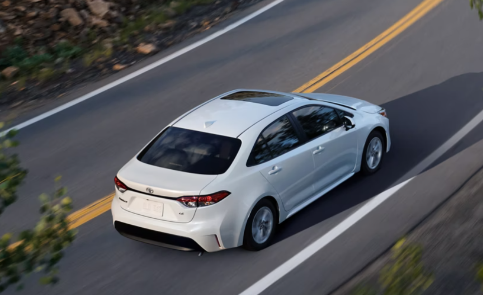 A 2023 white Toyota Corolla on the road.