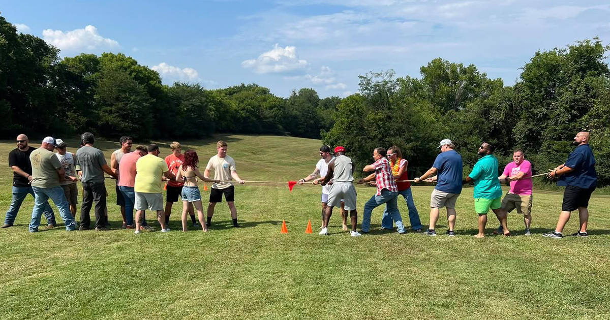The Wyatt Johnson Toyota team playing a friendly game of tug-o-war in a park
