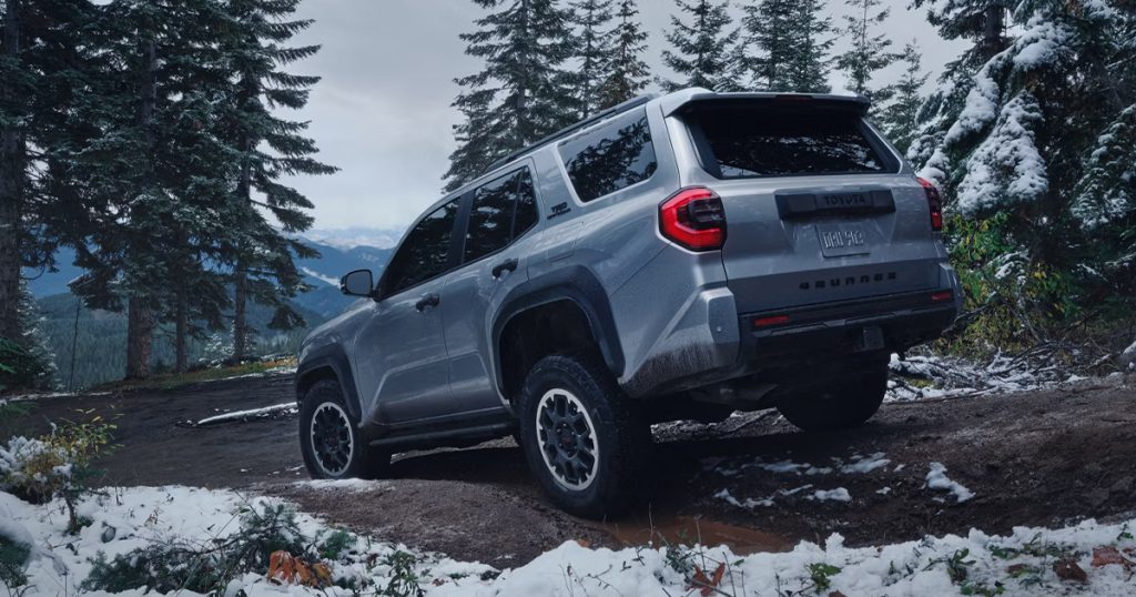 A Toyota 4Runner on snowy mountain terrain.
